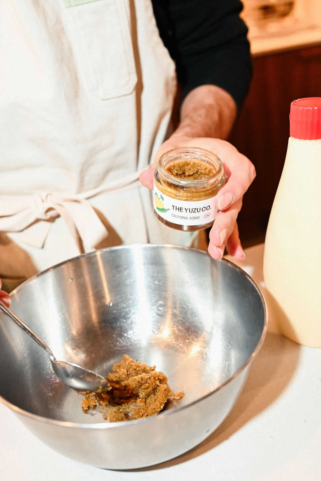 Hand holding jar of The Yuzu Co
