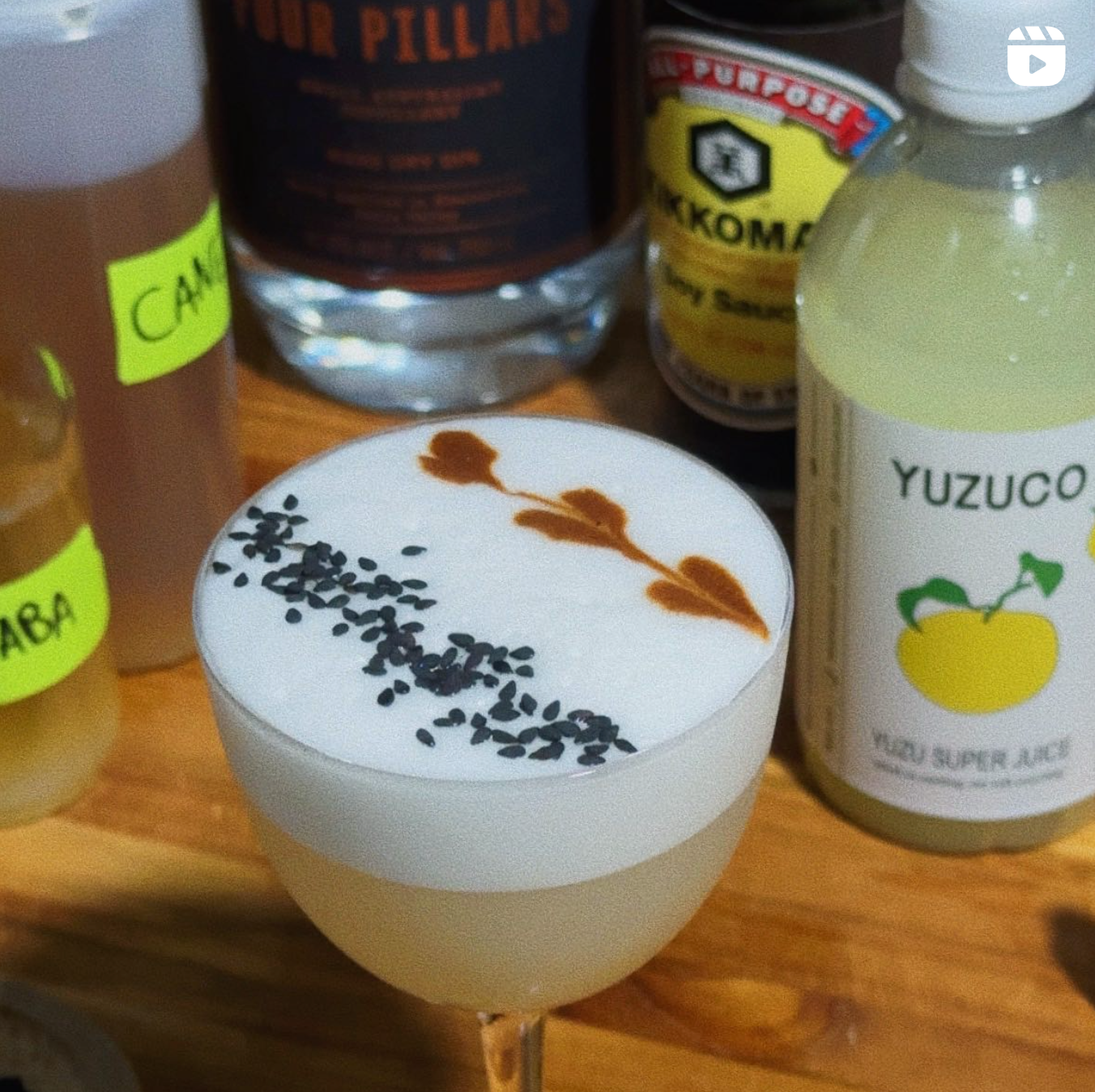 Yuzu ponzu sour next to yuzu super juice and other ingredients with heart design soy sauce and black sesame seed garnish in foam