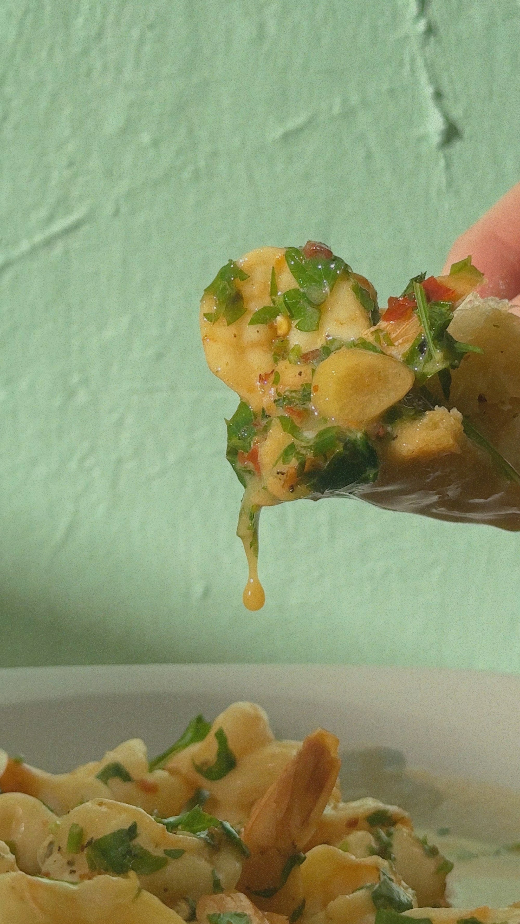 shrimp covered in yuzu juice and garlic dripping sauce onto plate