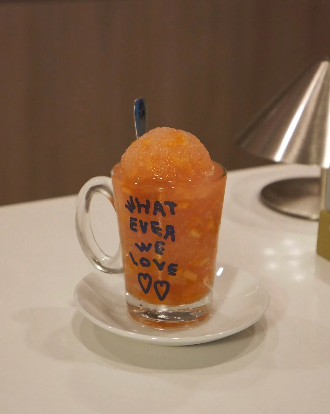 pink coconut guava yuzu slush in a small glass with a handle