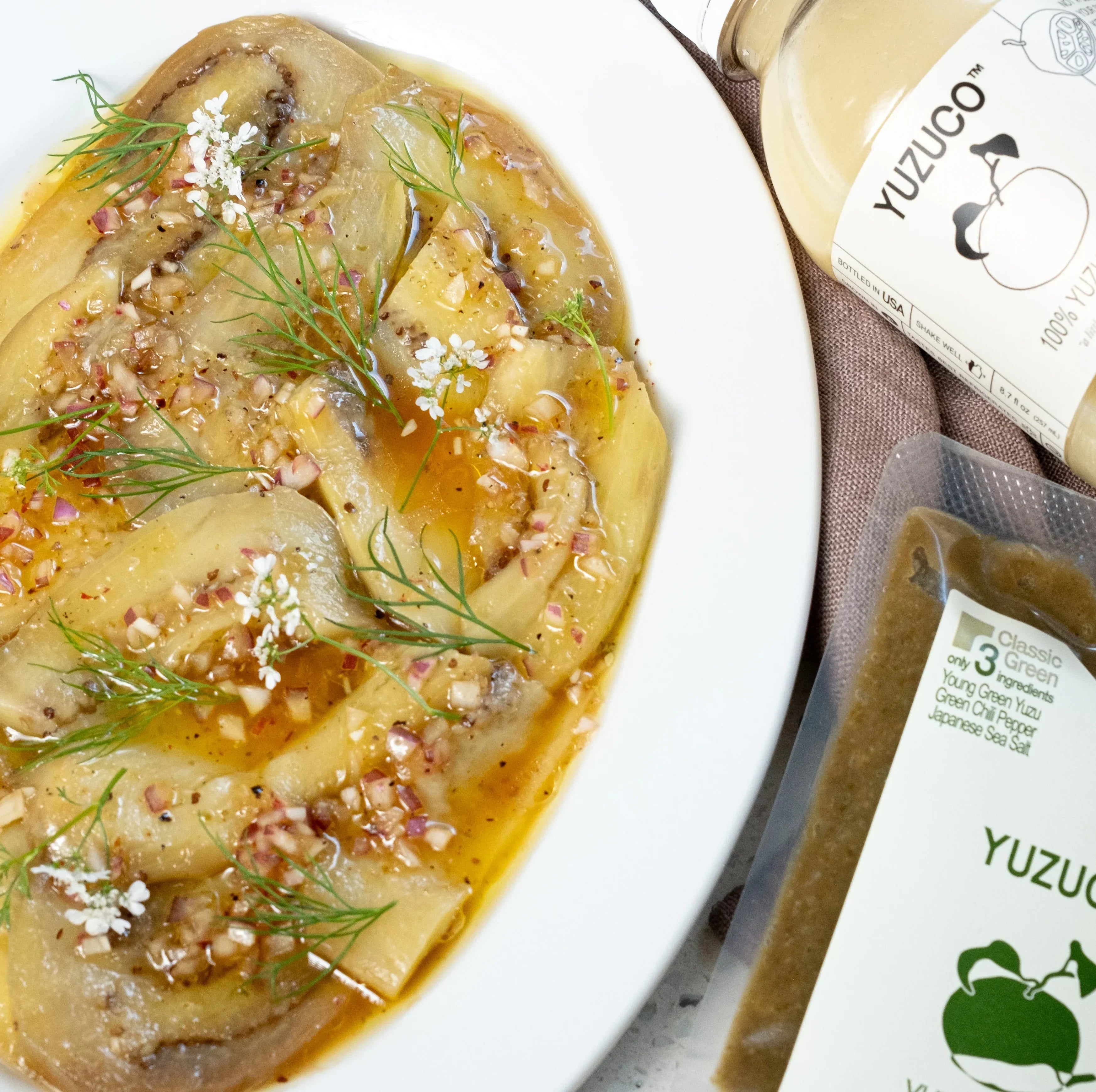 yuzu kosho eggplant carpaccio on a white plate