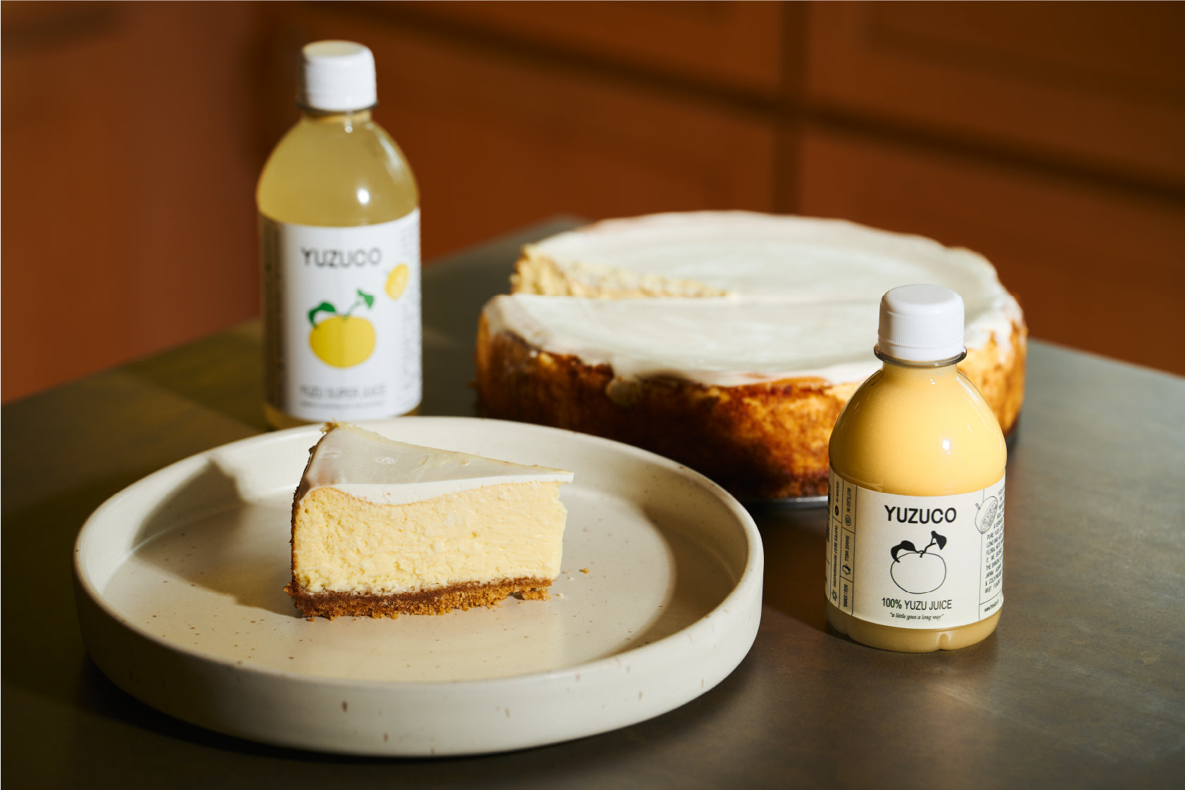 Yuzuco yuzu juice next to yuzu cheesecake 