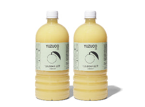 Front view of two 36.4oz bottles of 100% Sudachi Juice showcasing pale yellow juice and YUZUCO labels on white background