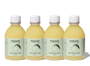 Front view of four 8oz YUZUCO 100% Sudachi juice bottles showing pale yellow juice and round labels on white background