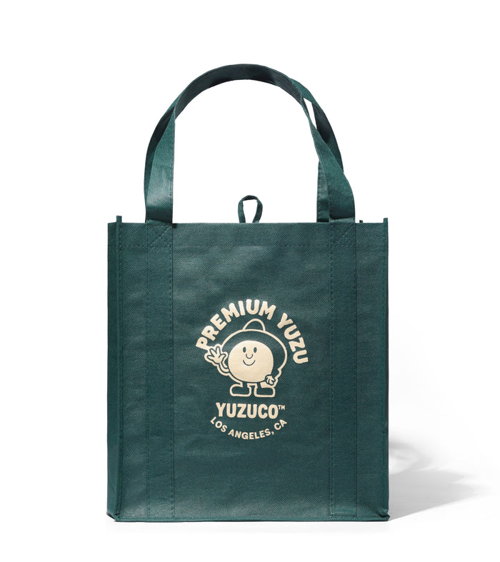Front view of Hand Picked grocery bag in sudachi green with cream PREMIUM YUZU YUZUCO Los Angeles CA logo and long handles