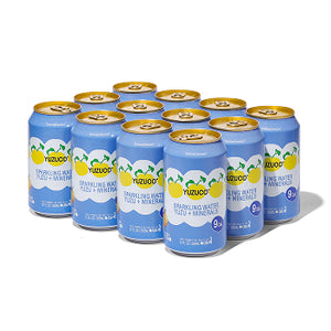 Front angled view of a 12-pack of Sparkling Yuzu + Minerals 12oz cans showcasing blue-and-white labels on a white background