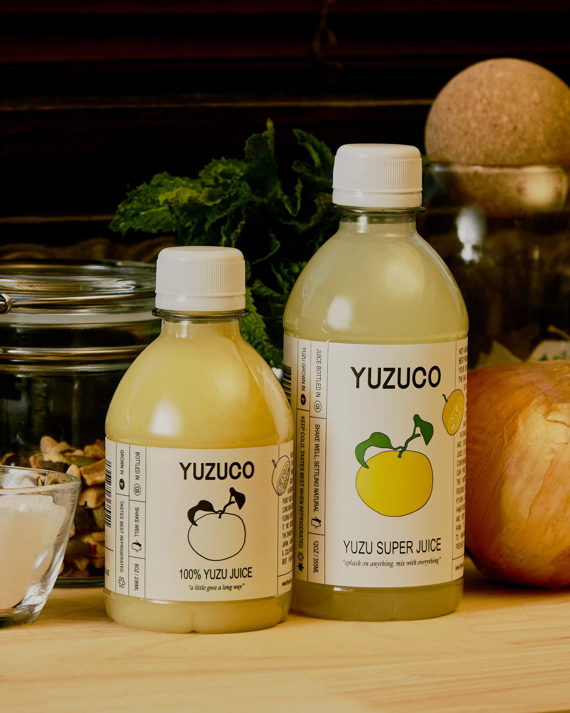 bottles of yuzuco yuzu juice next to other pantry items and produce