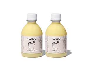 Front view of two YuzuCo 8.7oz bottles of 100% Yuzu Juice showing pale yellow juice and labels on white background