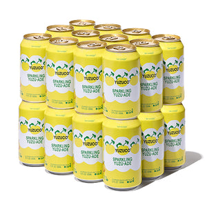 Front view of 24-pack of Sparkling Yuzu-Ade 12 fl oz cans showcasing yellow label with yuzu fruit pattern on white background