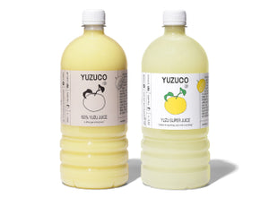 Front view of Yuzu Duo 1L 2-pack showing two labeled clear bottles of pale yellow yuzu juice side-by-side on white background