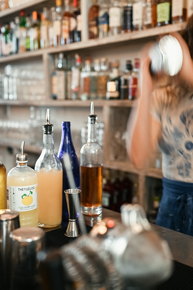 Bartender shaking yuzu super juice cocktail at botanica in los angeles