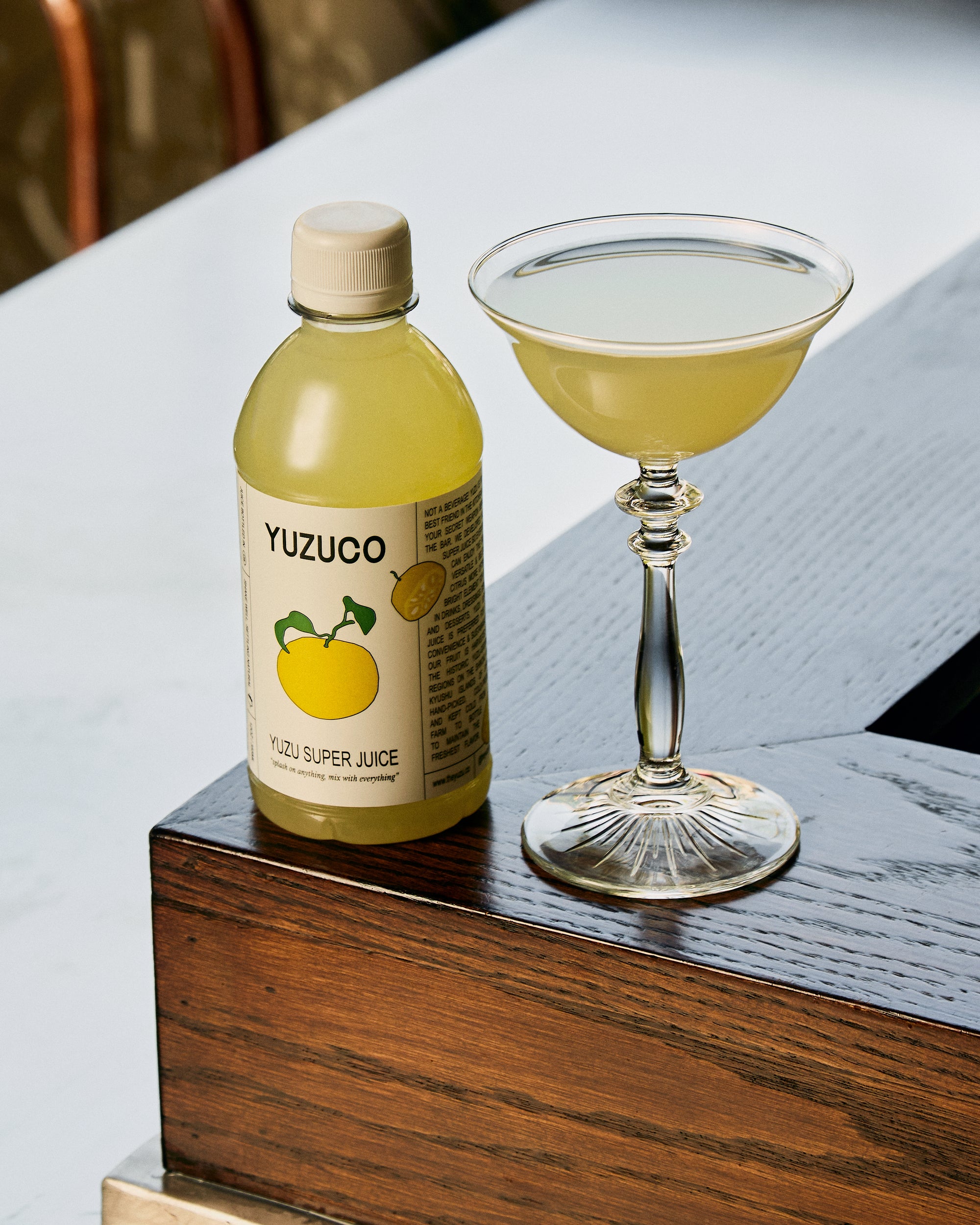 yuzu super juice by yuzuco next to a classic martini